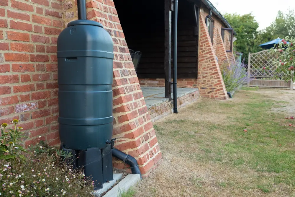 Système de récupération des eaux de pluie installé sur une habitation en briques
